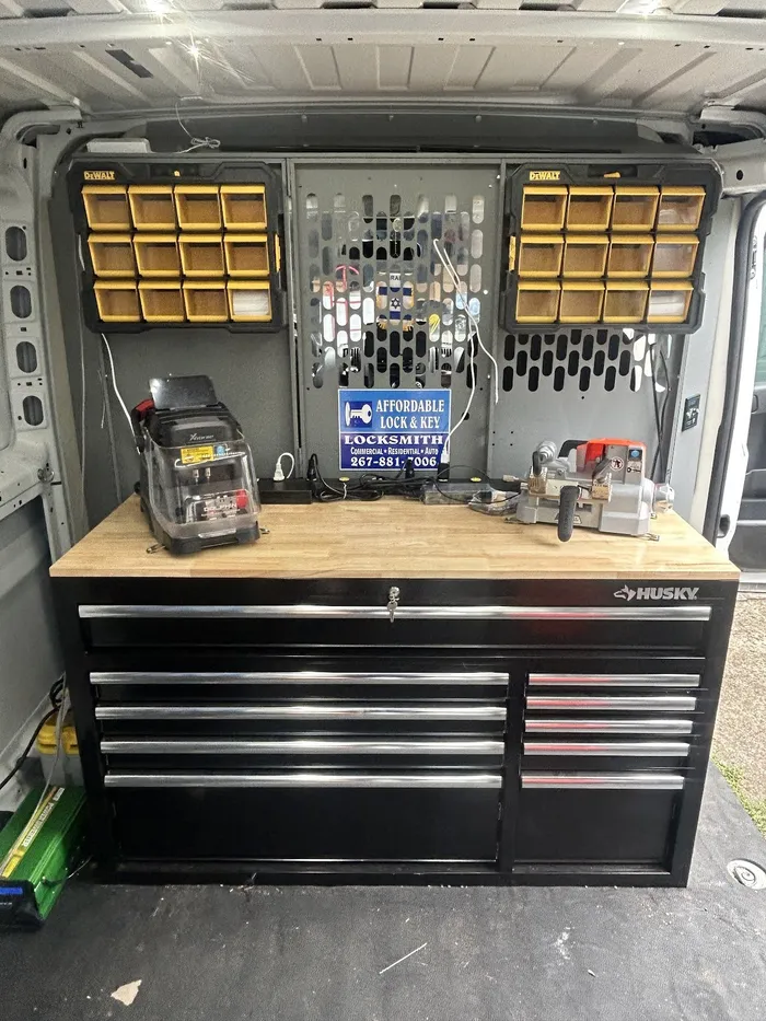Workbench, key machines and parts organizer inside the Affordable Lock & Key van