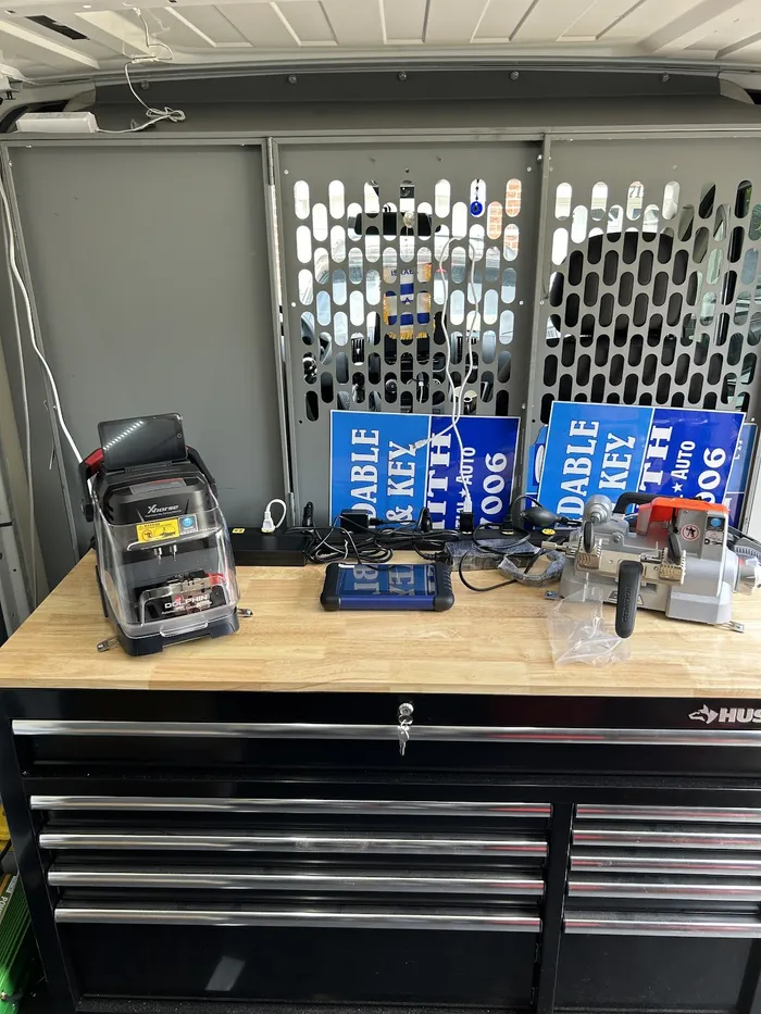 Key cutting machines on the workbench inside the locksmith van