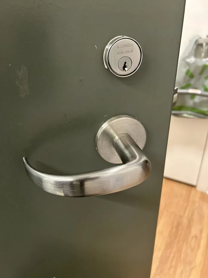 Commercial lever handle and deadbolt on a door