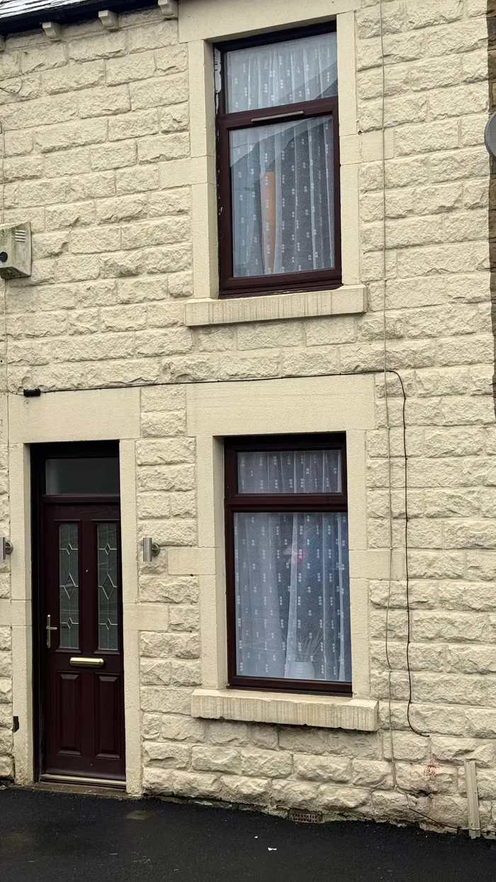 Stone-fronted terraced exterior of the Flow Stays home in Barnsley town centre