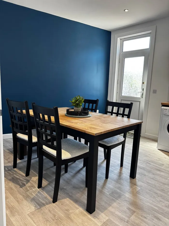 Dining area with dark blue wall at the Worsbrough home