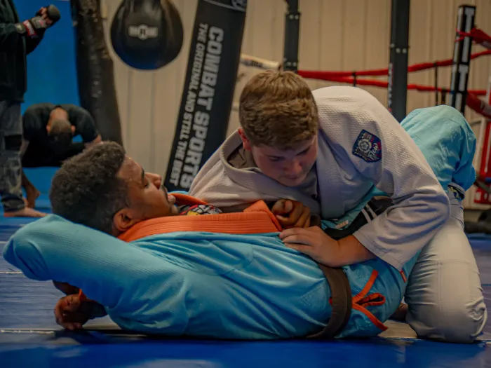 Training beside the heavy bags and boxing ring at Delta Grappling Academy