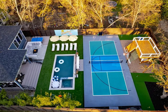 Pickleball court, plunge pool, turf and lounge built as one backyard