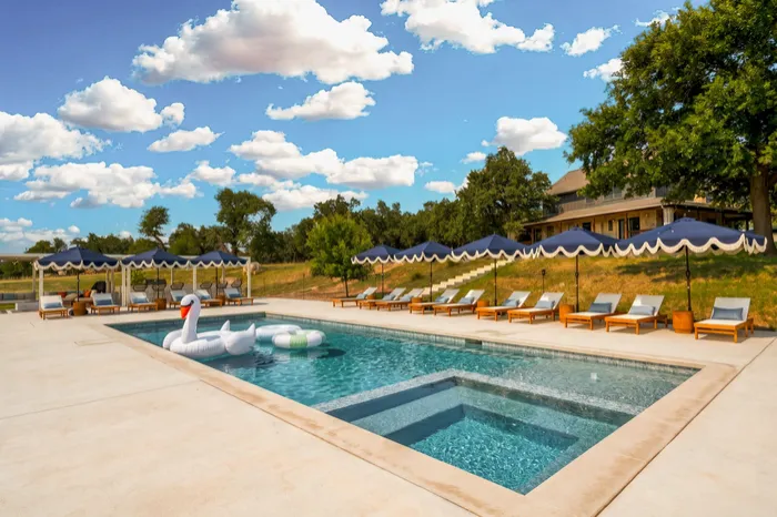 Pool and spa with scalloped umbrellas and loungers, Fredericksburg