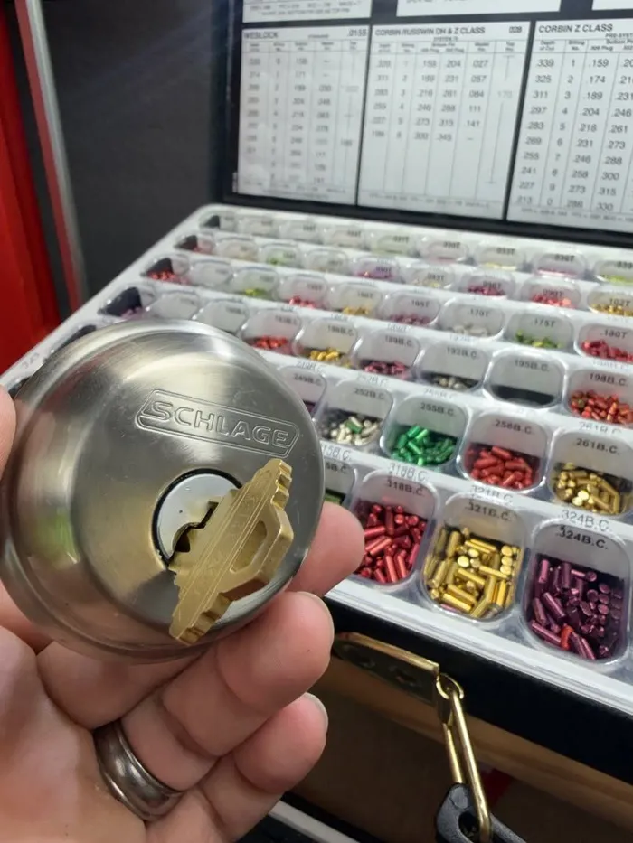 Schlage deadbolt cylinder and key over a rekeying pin kit