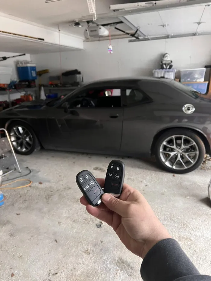Two smart keys for a Dodge Challenger in a garage