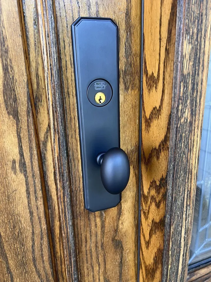 Black handleset on a wood front door