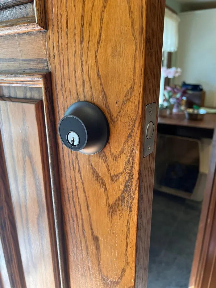 Black keyed deadbolt installed on a wood door