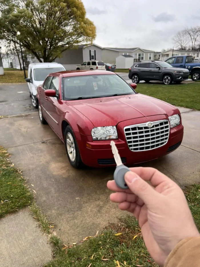 Transponder key held in front of a red Chrysler 300