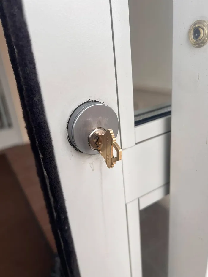 Mortise cylinder and key in a commercial storefront door