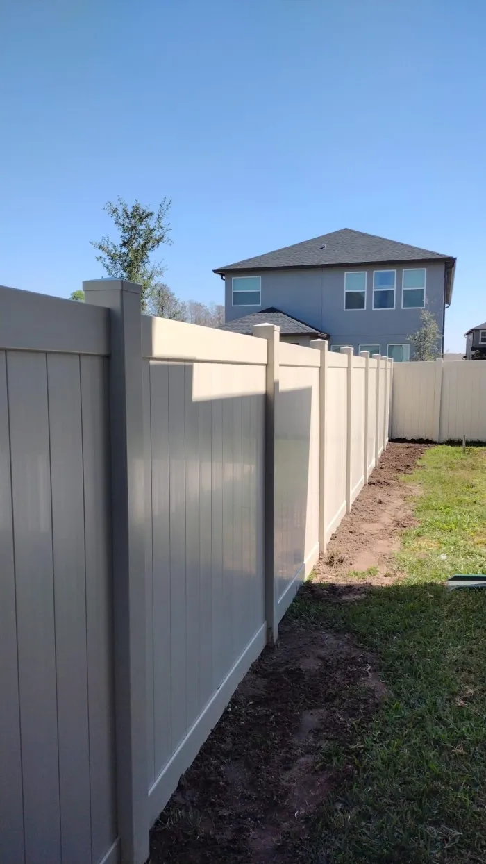Tan vinyl privacy fence