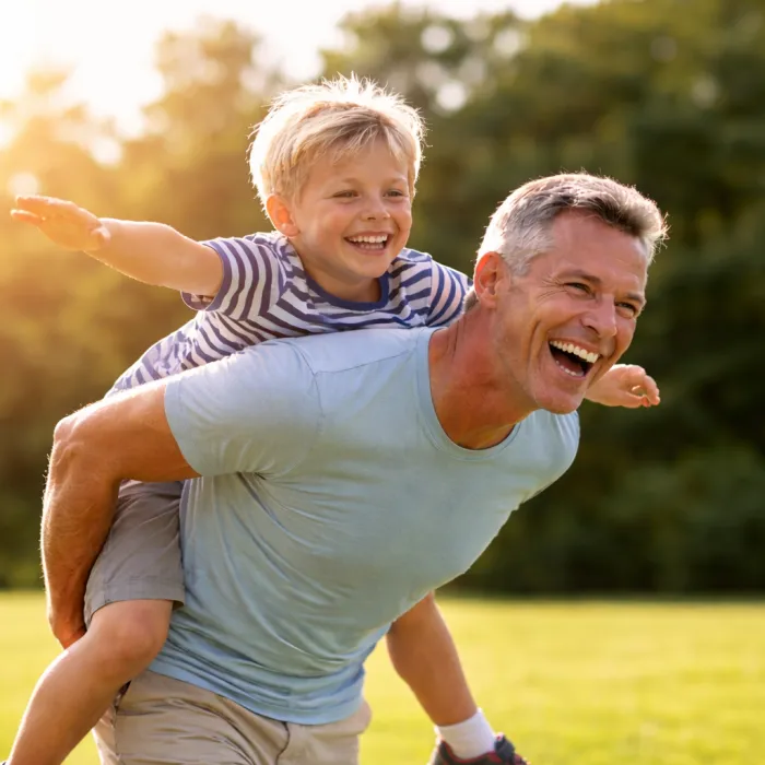 A grandfather giving his grandson a piggyback ride