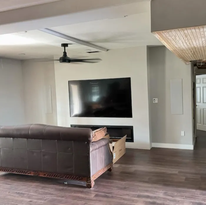 Living room with smooth walls around a built-in TV and fireplace
