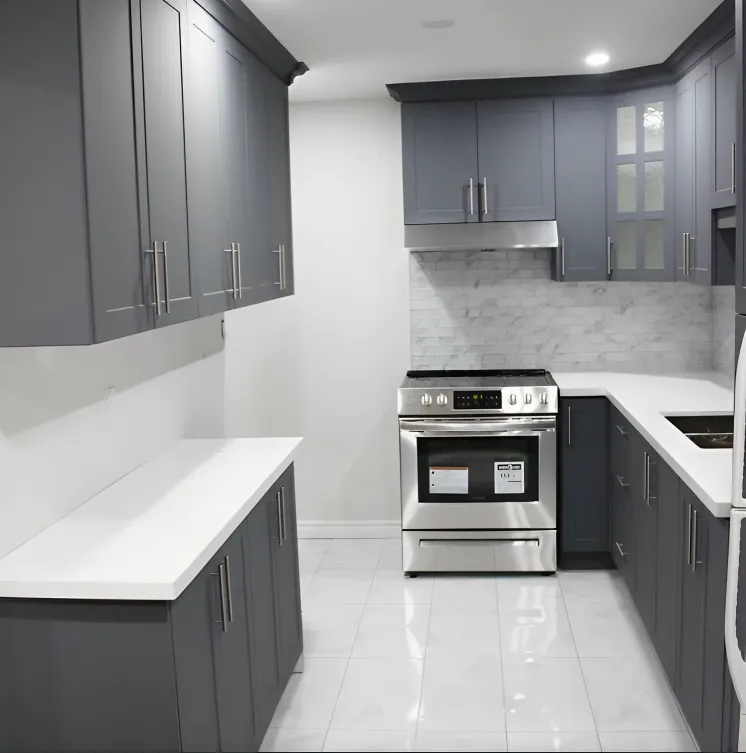 Grey kitchen cabinetry with stainless range and white quartz counters