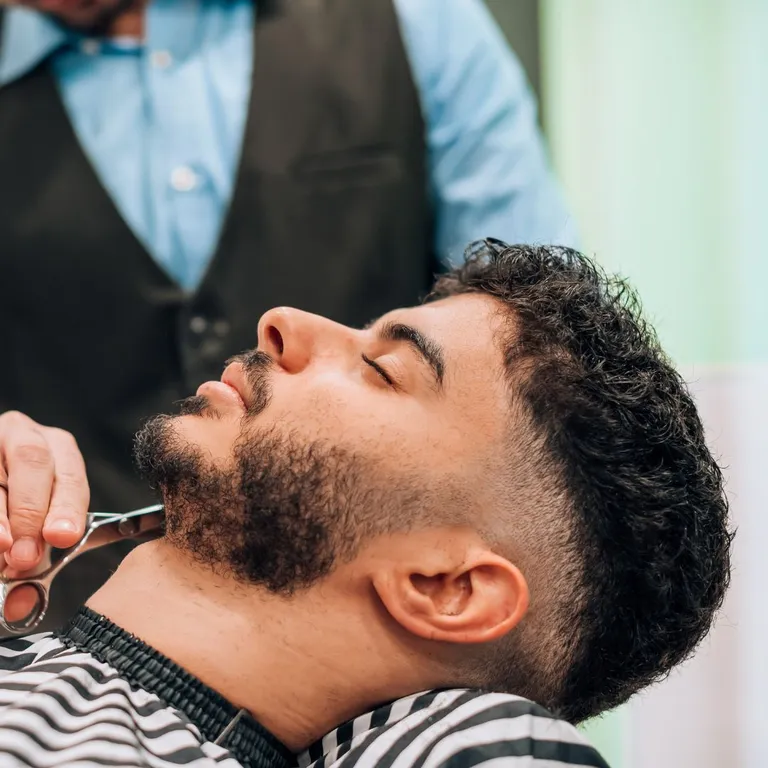 Man getting a beard trim at Salon Salman