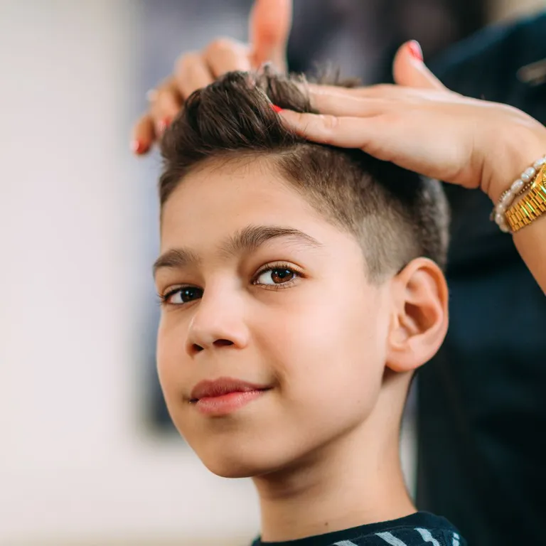 Young boy getting a fresh haircut at Salon Salman