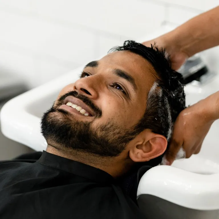 Client enjoying a hair wash at Salon Salman