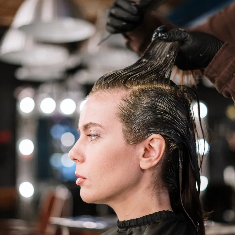 Woman getting a professional haircut at Salon Salman