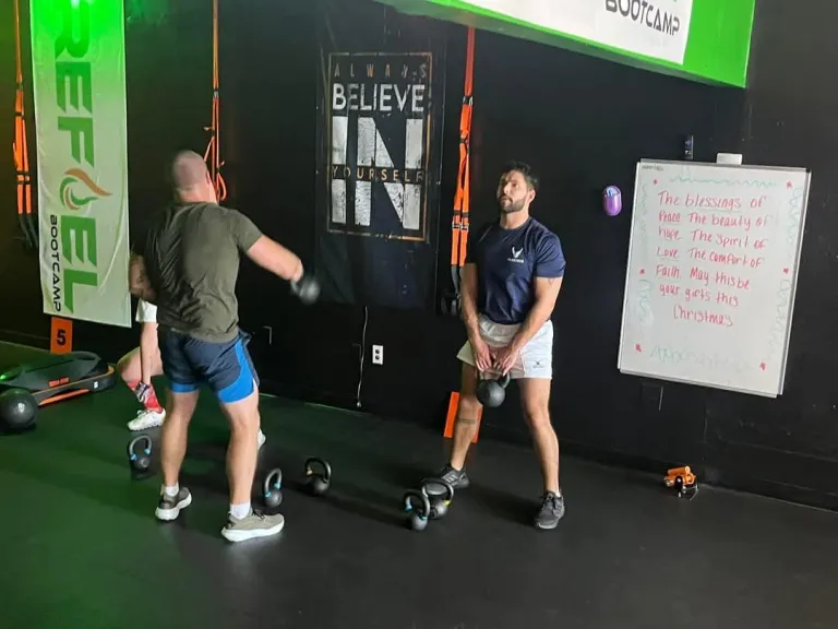 Coach working with a member at REFUEL Bootcamp Fort Walton Beach