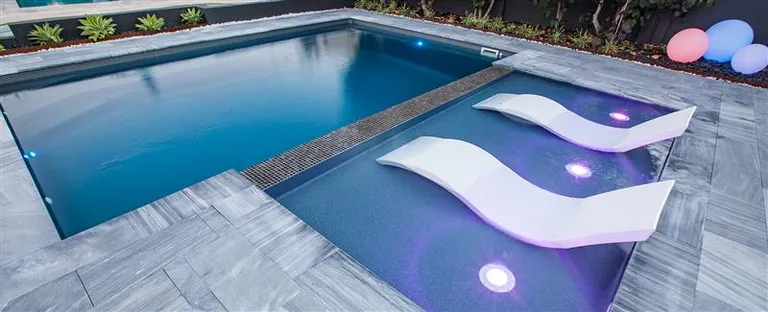 Aqua Ledge shallow pool platform beside a swimming pool