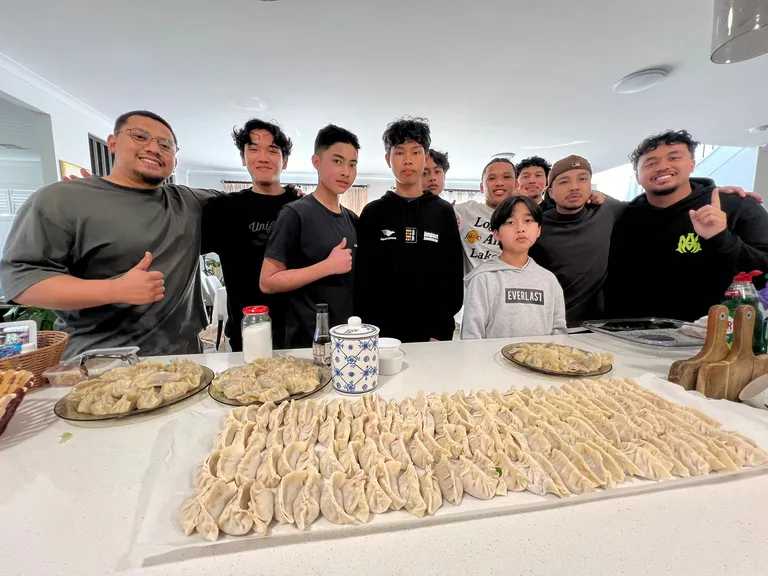 Brothers cooking together for an event