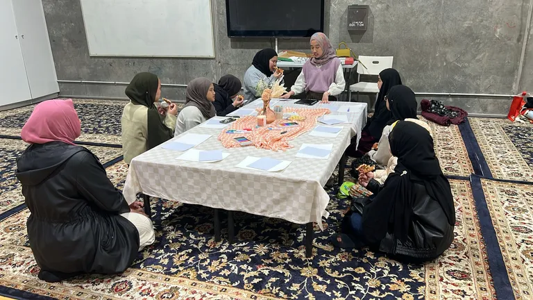 Sisters preparing food at a long table