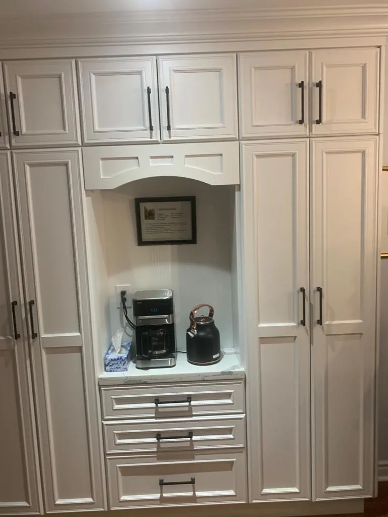 Built-in white pantry cabinetry with an integrated coffee station