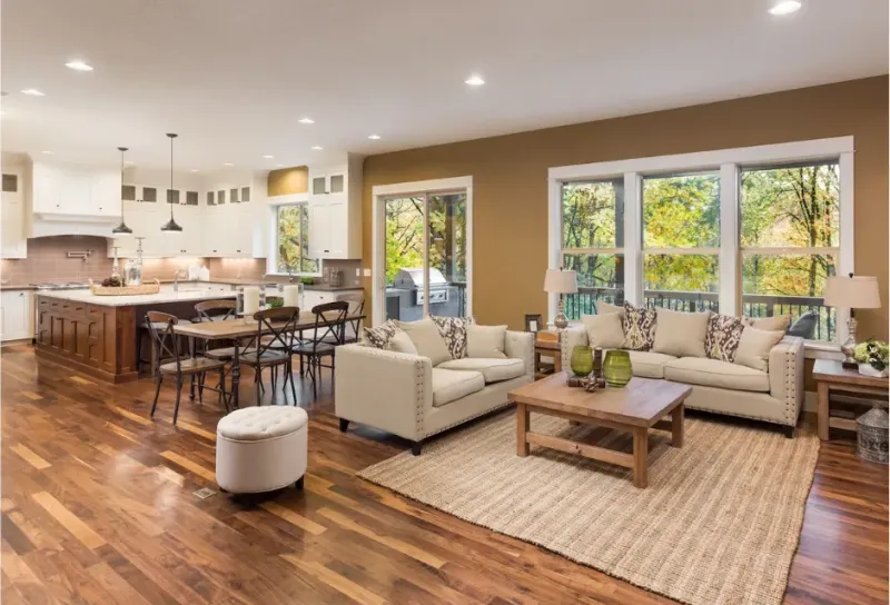 Continuous wide-plank hardwood flooring flowing through an open-concept home by CTC