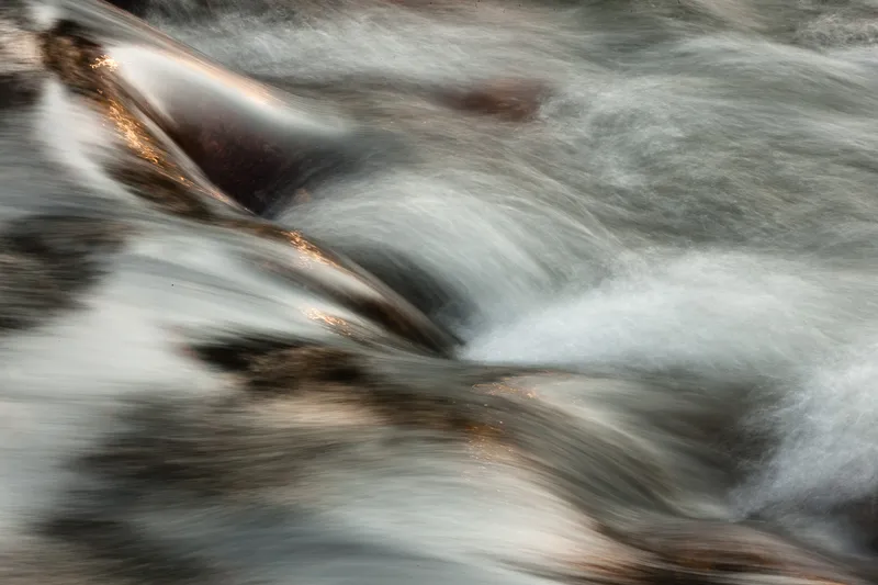 EARLY SUNSHINE ON RAPIDS