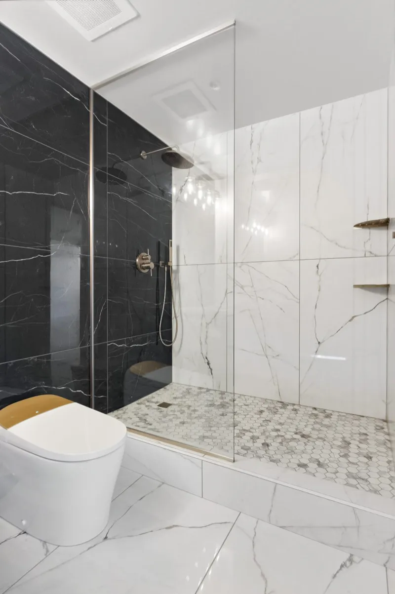 Contemporary bathroom remodel with two-tone marble shower