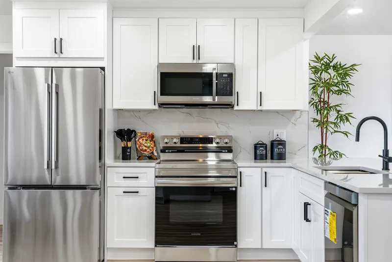 Full kitchen remodel with stainless appliances and marble backsplash