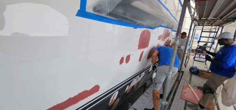 Aquamare technicians fairing the hull side