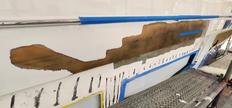Damaged laminate ground back along the hull side