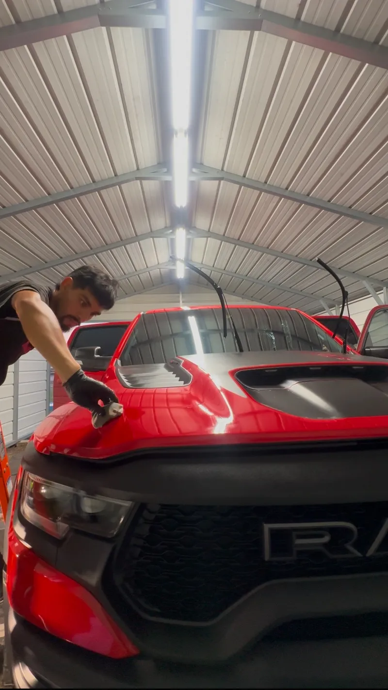 Polishing a red car before ceramic coating