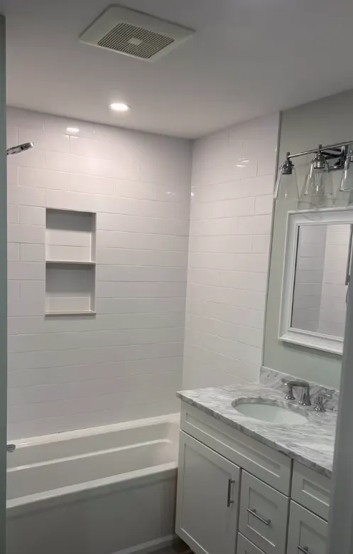 Tub and shower surround finished with white subway tile
