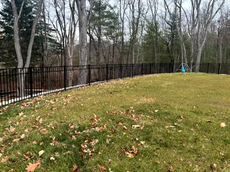 Black aluminum fence around a backyard by All Fenced In
