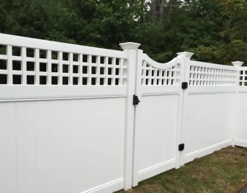 White vinyl privacy fence with lattice top and gate by All Fenced In