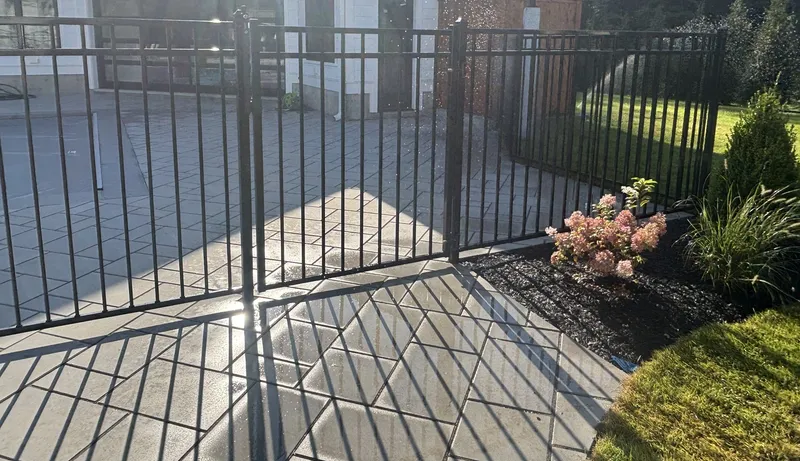 Black aluminum double gate on a patio in North Reading by All Fenced In