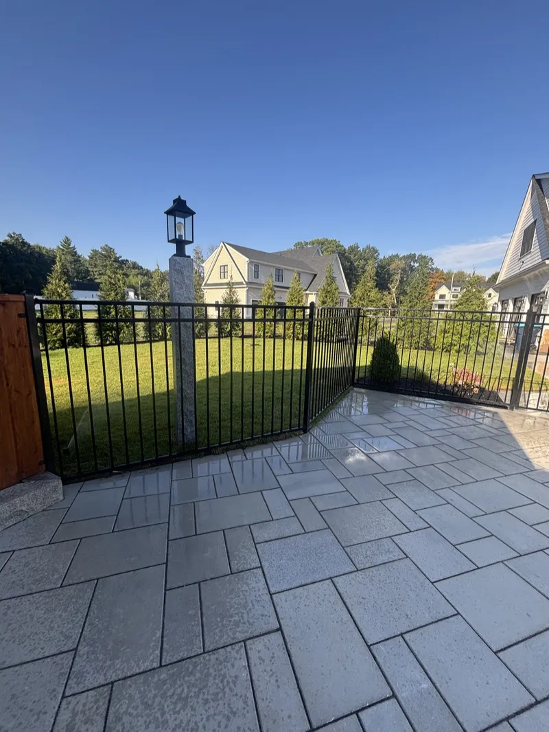 Black aluminum fence at a patio corner in North Reading by All Fenced In