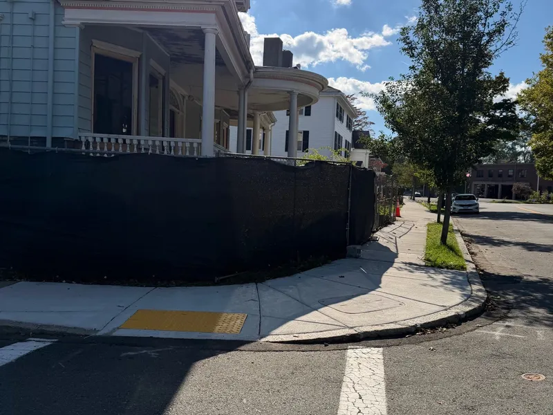 Black chain link fence at a street corner by All Fenced In