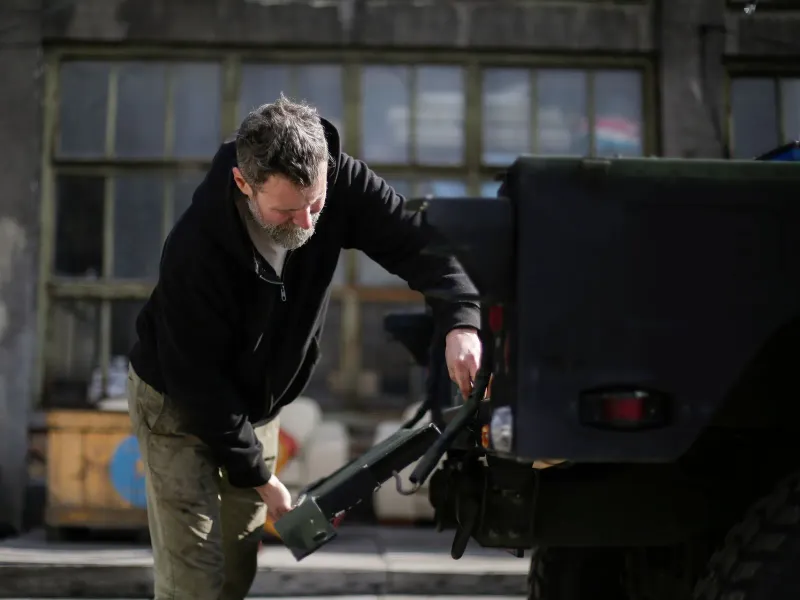 A worker packing up at the back of his truck