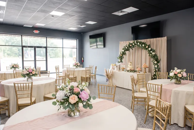 Event room set for a bridal or baby shower with a dessert table and gift table