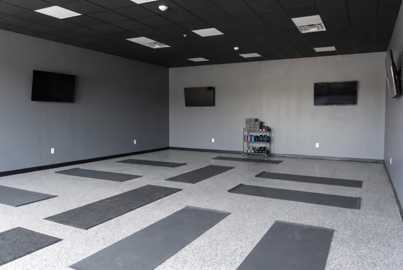 Open event room set up as a fitness studio with exercise mats on the floor