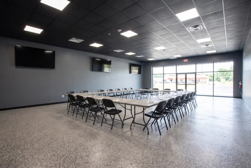 Event room set for a business meeting with folding tables in a conference layout