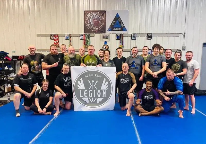 Legion Project no-gi class of veterans and first responders holding the Legion banner