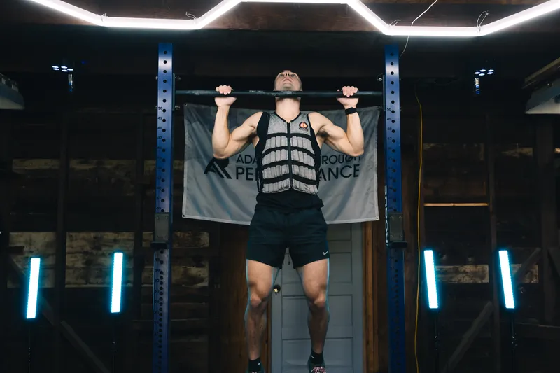 Jonathan doing a weighted pull-up
