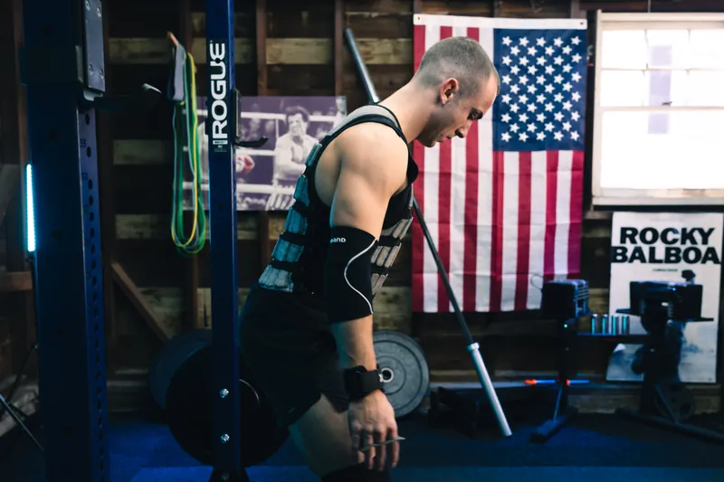Jonathan training next to the American flag in his garage gym