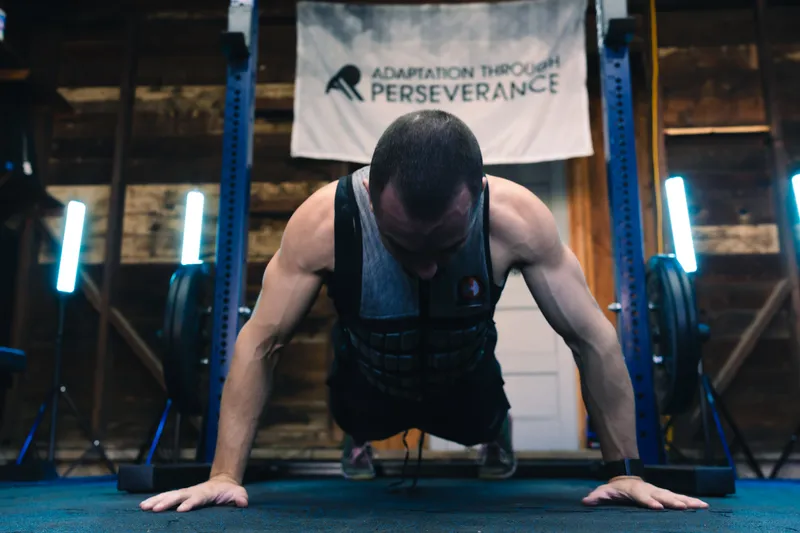 Jonathan doing a push-up in a weight vest