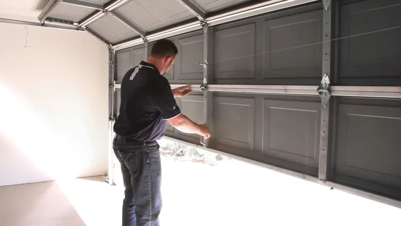 Garage door technician inspecting a residential garage door in East Texas