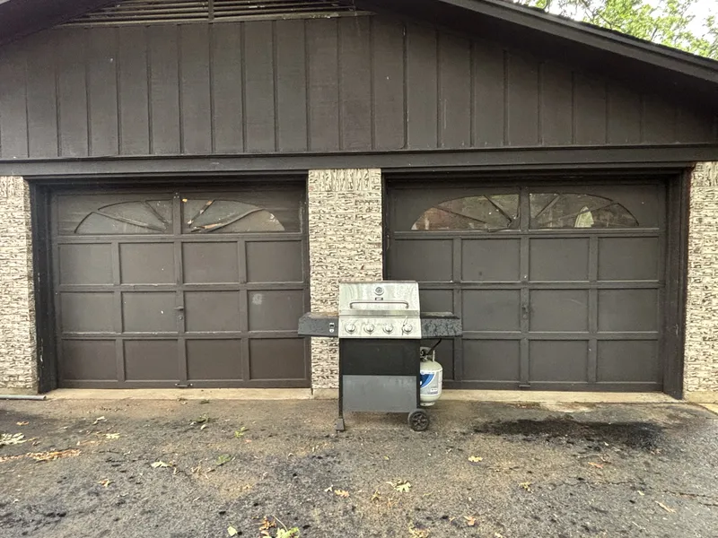 Old garage doors before replacement by Dynamic Door Service in East Texas